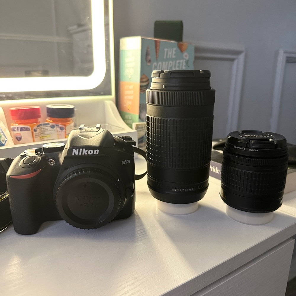 Nikon D3200 DSLR Camera with Black Body and Two Black Zoom Lenses